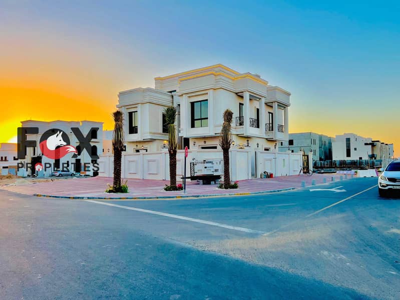 Luxury classic corner villa for sale in Al Helio 2, Ajman. Opposite park, 6 master bedrooms, pool, 4,300 sq. ft land, 5,000 sq. ft built-up. AED 3.2M.